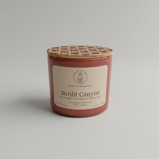 Candle labeled 'Sunlit Canyon' on a marble surface